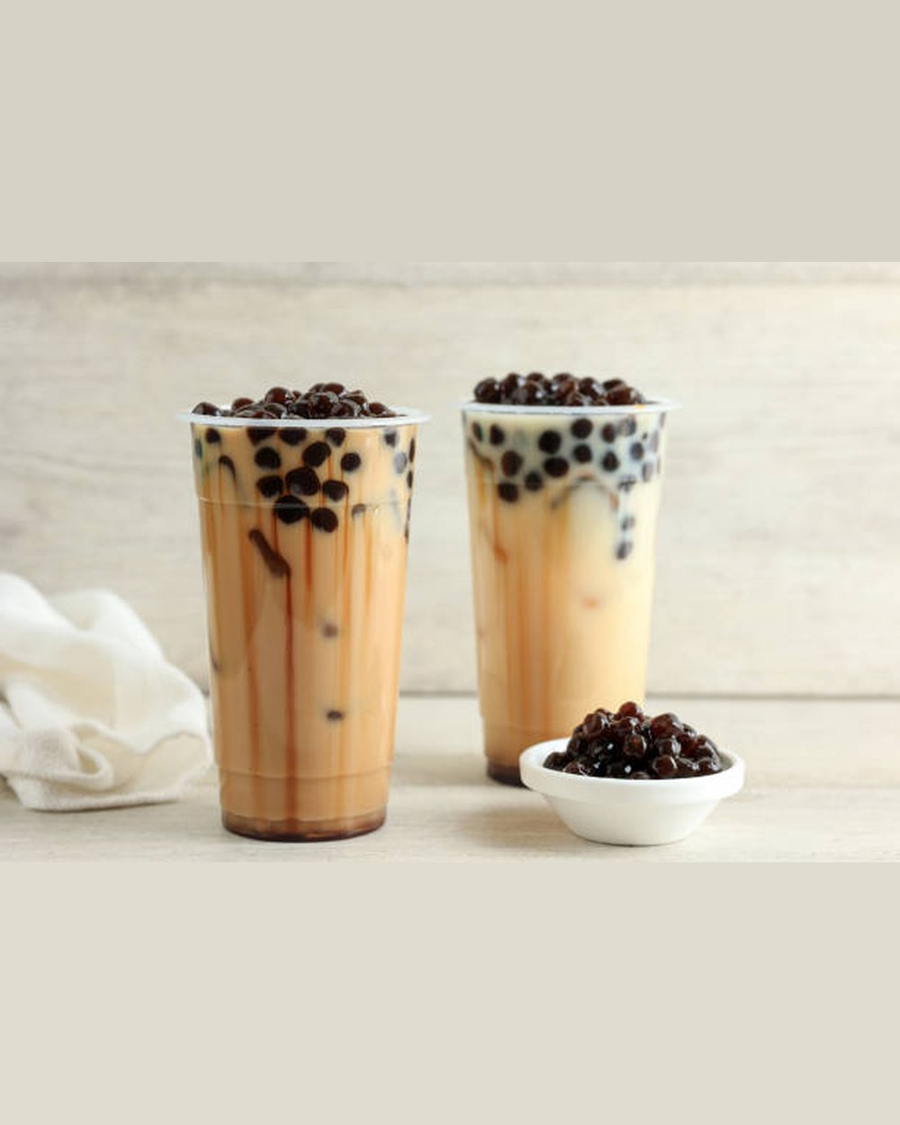 Two milk teas with tapioca pearls